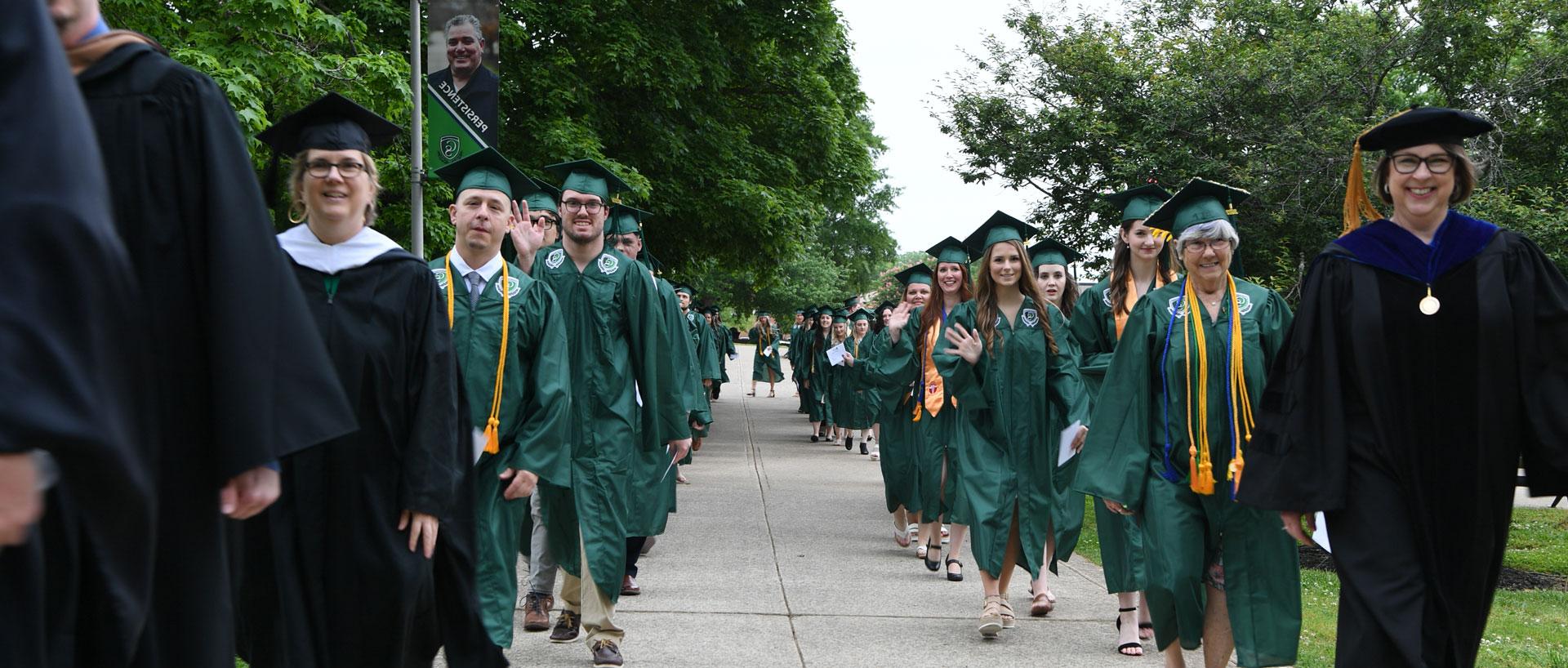 graduates walking on campus